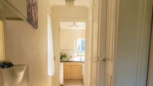 A hallway with a doormat that reads "A House is Built on a Foundation of Love, but a Home is Built on a Foundation of Love." -  1 bedroom 1 bathroom apartment in a quiet street in the heart of Chelsea, (London)