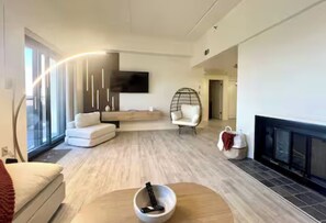 A modern living room with a sofa, armchair, and a fireplace. - New! Coco Chateau Pool/HotTub/Incredible MtnViews (Sugar Mountain)