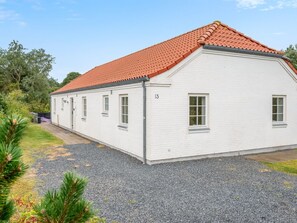 A single-story building with a red-tiled roof, numbered 13, and a gravel driveway. - "Marjatta" - 3.2km from the sea by Interhome (Blåvand)