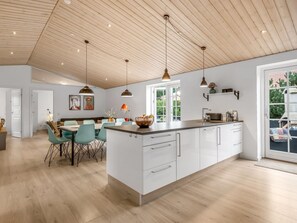 A spacious kitchen with a large island, pendant lighting, and a view to the outside. - "Marjatta" - 3.2km from the sea by Interhome (Blåvand)