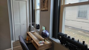 A room with a wooden desk, a globe, a model train, and a guitar. - Highlands Hideaway - Walk to Bars, Food & Coffee (Louisville)