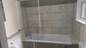 Combined shower/bathtub, deep-soaking bathtub, hair dryer, towels