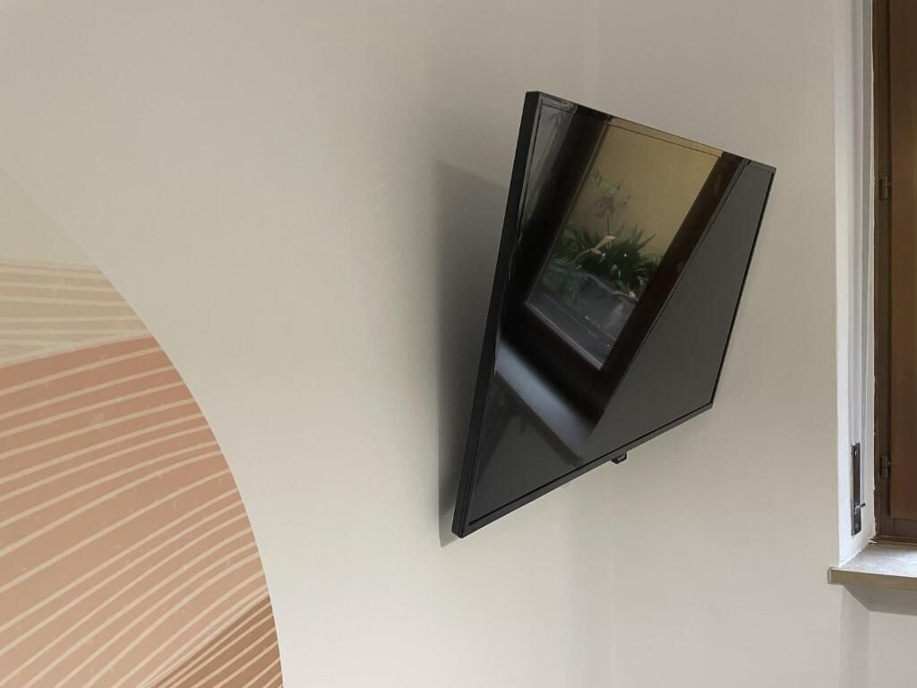A flat-screen TV mounted on a plain wall.