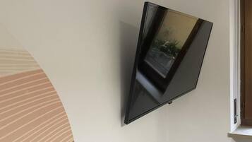 A flat-screen TV mounted on a plain wall.