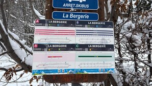 A bus stop sign with multiple route schedules and QR codes for digital access. - Cosy 6-person apartment in Chinaillon (Le Grand-Bornand)