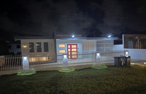A modern house with a white exterior, a red door, and a white fence. - Casa Marty. Spacious 4-bedroom house in pleasant Aguadilla with cool AC breeze. (Aguadilla)