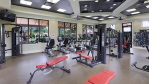A gym with various exercise equipment, including treadmills, weight machines, and benches. - Beautiful 2-bedroom house in a perfect Bonita Springs location (Bonita Springs)