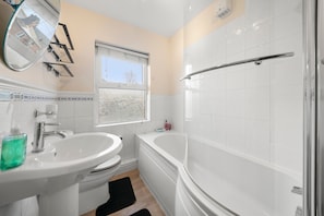 Separate bathtub and shower, deep-soaking bathtub, hair dryer, towels