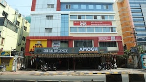A hotel with a sign for Sri Sai Regency and a restaurant named Amogh. - Hotel Sri Sai Regency (Hyderabad)