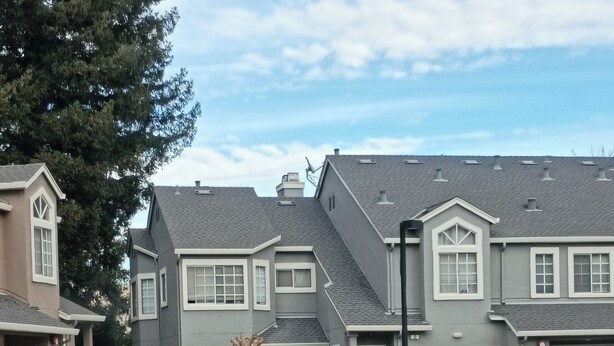 A residential street with modern two-story houses, a clear sky, and trash bins in the driveway. - Beautiful Gated 2-bedroom 1 bath Condo with fireplace in fabulous Hayward. (Hayward)
