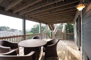 Unwind on your spacious covered deck with comfortable seating while enjoying tree-lined views and peaceful natural surroundings.