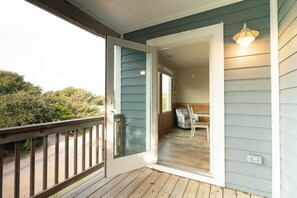 Step onto your private balcony with serene treetop views, where morning coffee and evening relaxation await in perfect harmony.