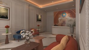 A modern hotel lobby with a reception desk, seating area, and artwork on the walls. - Binh Minh Sapa Hotel (Sa Pa)