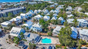 An aerial view of a coastal residential area with a swimming pool surrounded by houses. - YOUR BEST BEACH VACATION EVER  POOL GOLF CART BIKES VERY CLOSE TO BEACH (Santa Rosa Beach)