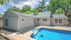 A residential property with a swimming pool, a covered patio, and a garage. - Resort-Style Retreat w/ Pool, Prime OP Location (Mission)