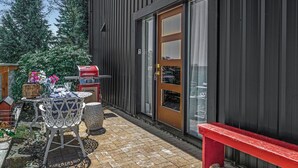 A patio area with a table and chairs, a red bench, and a grill. - Farm barn with territorial view in Banks w/ pheasants- 1 hour drive to coastal (Banks)
