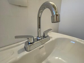 A bathroom sink with a chrome faucet and a single-handle design.
