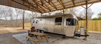 Johnny's Lake Escape lakeside covered Airstream: firepit, outdoor seats; kayaks