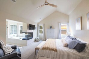 A bedroom with a bed, a desk, a chair, a window, and a ceiling fan. - Soundfront Corolla Home with Hot Tub & Sunset Views! (Corolla)