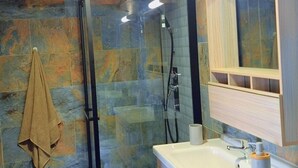 A modern bathroom with a glass shower enclosure, a wooden ceiling, and a large mirror above the sink. - Emma modern suite (2-minute walk from the beach). (Kourou)