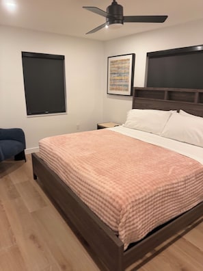 A bedroom with a bed, a ceiling fan, a nightstand, a chair, and a window. - Stay Near the Action - Miami Hard Rock Stadium, Casinos, and Beaches (Miami)