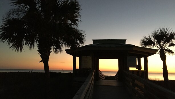 A wooden gazebo with a roof, surrounded by palm trees, overlooking a beach at sunset. - BeachDaze - Crosswalk to Beach Access, Private Pool (Panama City)