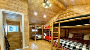 A cabin with wooden walls and floors, bunk beds, a staircase, and a window. - Walk to Lake, Downtown, Restaurants and Shops- Grand Mountain Haven (Grand Lake)