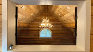 A wooden ceiling with a chandelier and a stained glass window. - Walk to Lake, Downtown, Restaurants and Shops- Grand Mountain Haven (Grand Lake)