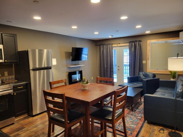 A compact living space with a kitchen, dining area, and seating area.