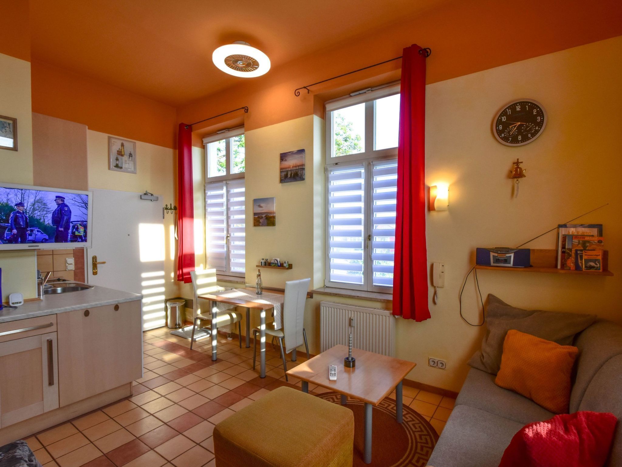 A compact living space with a kitchenette, dining area, and seating area.