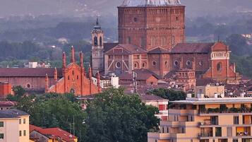 A historic church with a prominent dome and bell tower, surrounded by residential buildings and greenery.