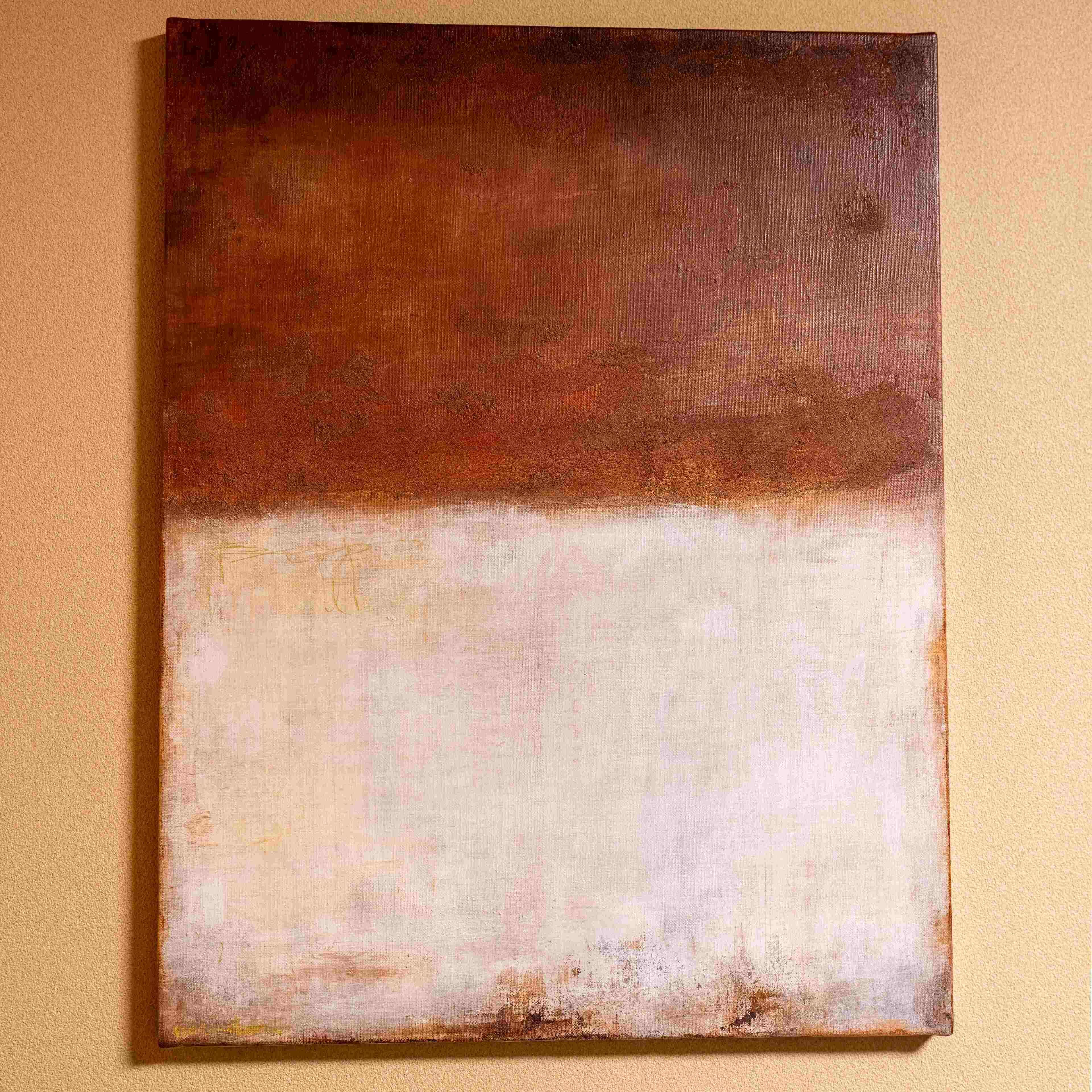 A painting with a gradient from dark brown to light beige on a textured wall.