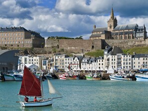 A harbor with boats, a castle, and historic buildings. - "Les flots bleus" (Die blauen Strände) by Interhome (Saint-Pair-sur-Mer)