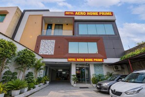 Un hotel modern amb un cartell prominent que diu 'HOTEL AERO HOME PRIME'.