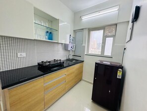 Fridge, stovetop, cookware/dishes/utensils, dining tables - 2BR Service apartment C - 1207 Malad by Florastays (Mumbai)