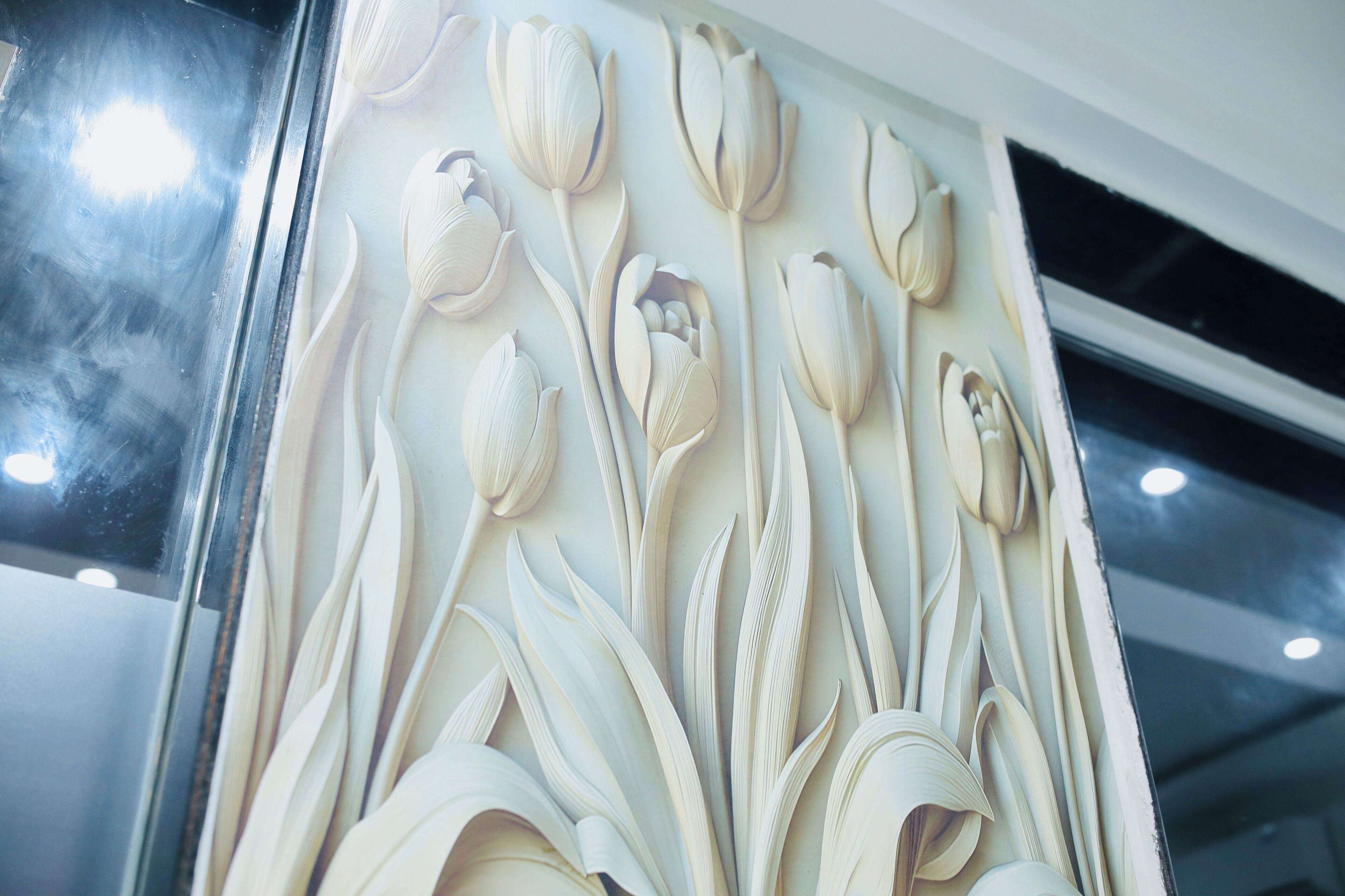 A wall with a floral relief design.