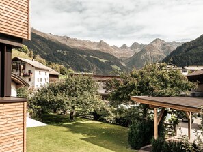 A mountain view with a wooden deck and a building with balconies. - Apart  Bieles NEU by Interhome (Kauns)