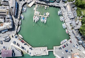 A marina with boats docked, a pedestrian walkway, and a parking area. - Hardys is a charming traditional fisherman's cottage nestled in the heart of Padstow (Padstow)