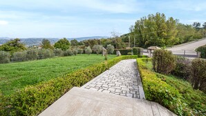A paved pathway leading through a well-maintained garden with a view of distant hills. - 3 bedroom gorgeous home in Torre Le Nocelle (Torre Le Nocelle)
