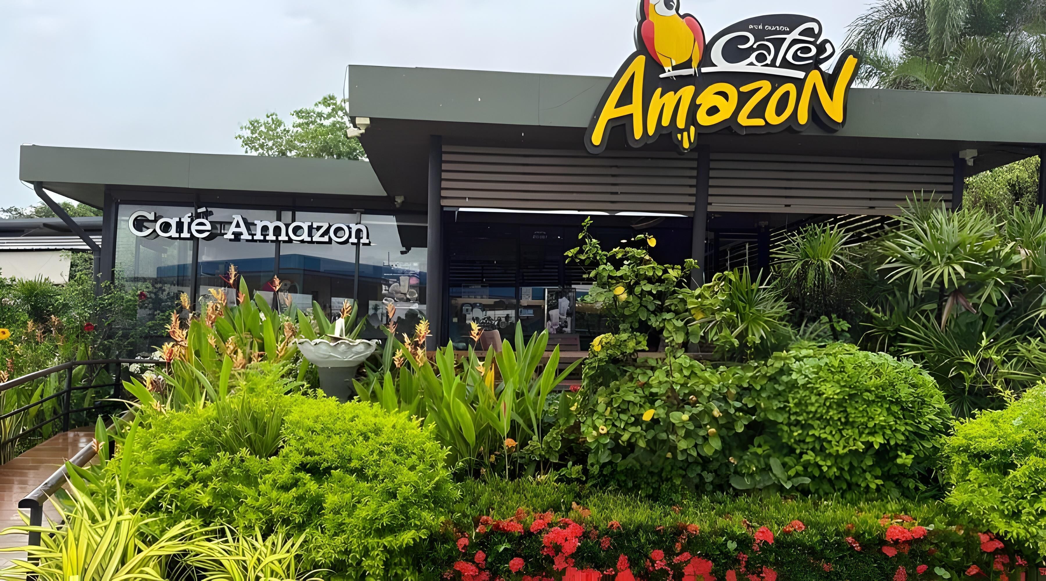 A building with a sign reading "Cafe Amazon" and "Cafe Amazon" on the side.