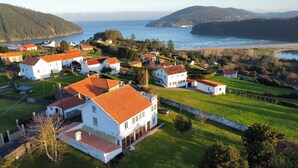 A coastal village with white houses, red roofs, and a view of the sea.