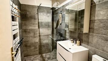 Shower, towels, soap, toilet paper