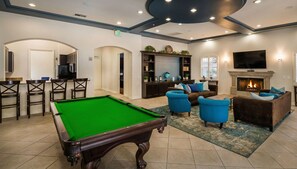 A pool table in a well-lit room with a fireplace, comfortable seating, and a television. - 1 Bedroom Sunset Escape In Marina Del Rey (Marina del Rey)