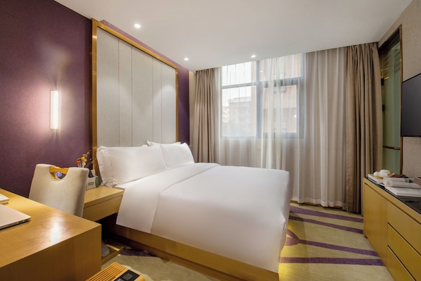 A hotel room with a bed, a desk, a chair, a TV, and a window with curtains. - PCLJ Hotel Bao'an Centra (Shenzhen)