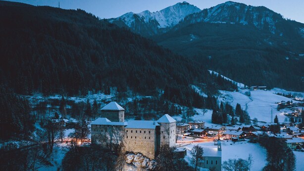 A historic castle with multiple towers, surrounded by a snowy landscape and a small village. - Grandview Collection Luxus-Wohnung in Kaprun by Interhome (Kaprun)