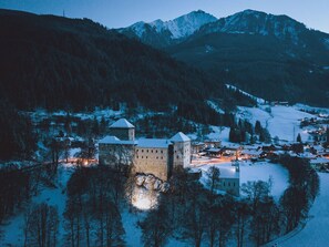 A historic castle with multiple towers, surrounded by a snowy landscape and a small village. - Grandview Collection Luxus-Wohnung in Kaprun by Interhome (Kaprun)