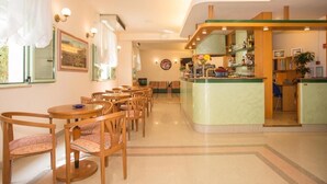 A hotel lobby with a bar area, seating arrangements, and a reception desk. - Hotel Dover Rooms & Coffee - Adults Friendly (Cervia)
