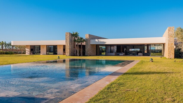 A modern house with a swimming pool, stone pillars, and a large patio area. - LUXURY ARCHITECT VILLA 5 SUITES (Marrakech)
