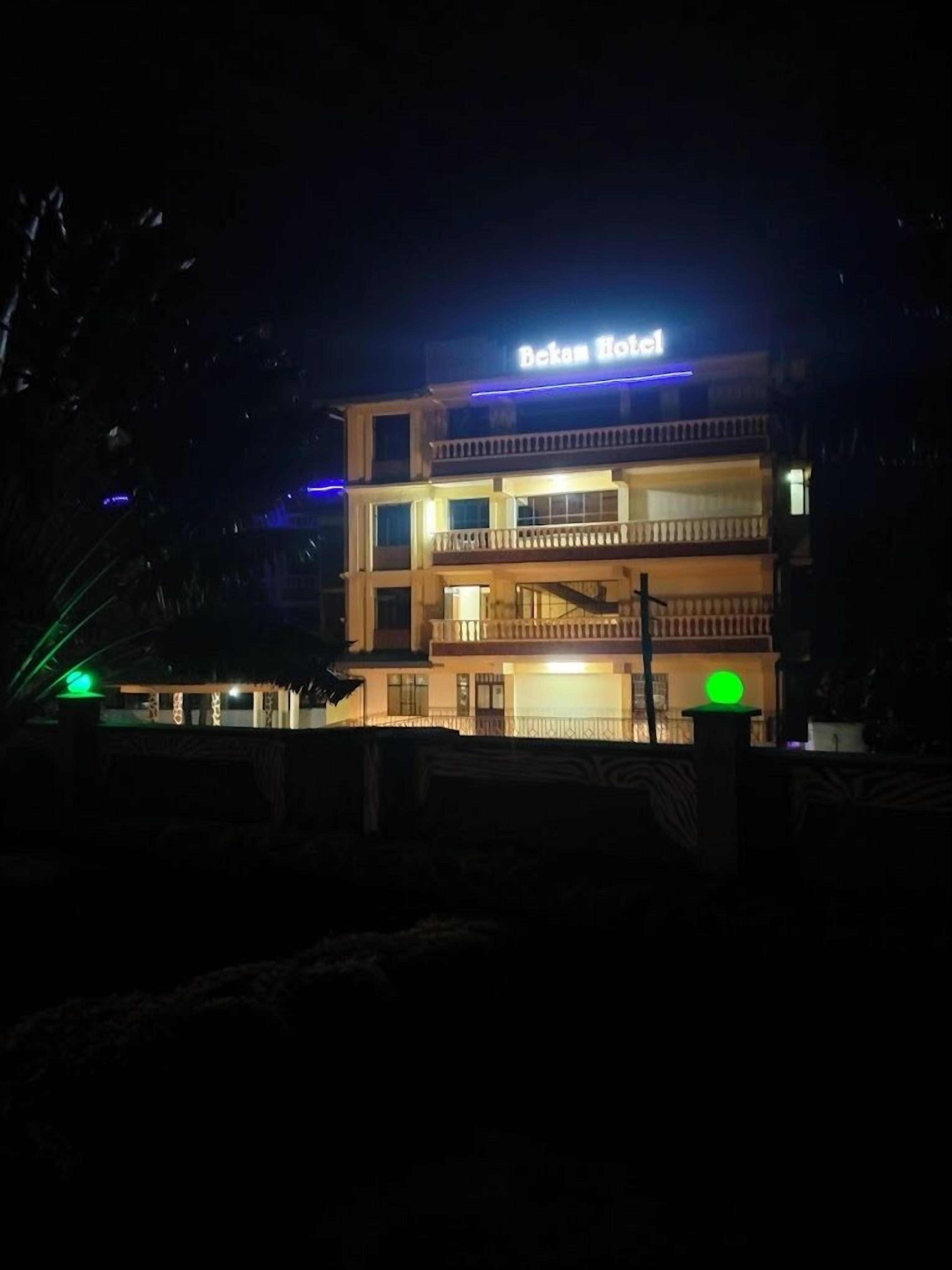 A multi-story building with a sign that reads "Bekam Hotel".