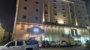 A multi-story hotel with a prominent sign reading "Al-Akaf" at the top. - Amaken For Residential Units (Al-Hofuf)